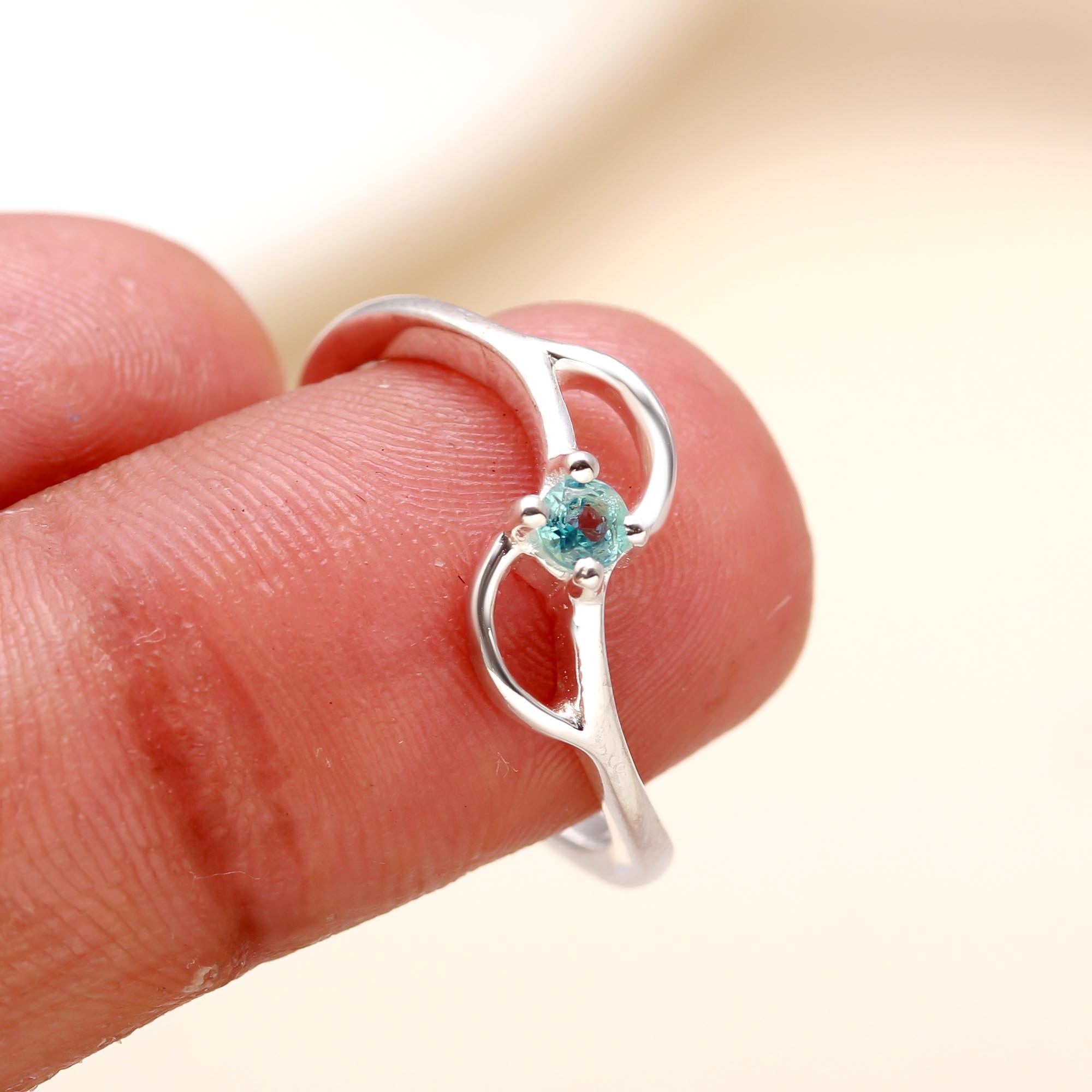 Sterling silver twisted band ring with blue topaz gemstone