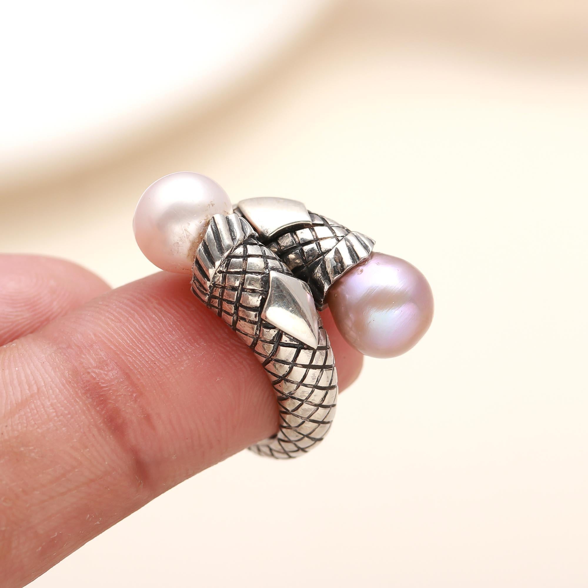 Nature-inspired snake and pearl ring on finger