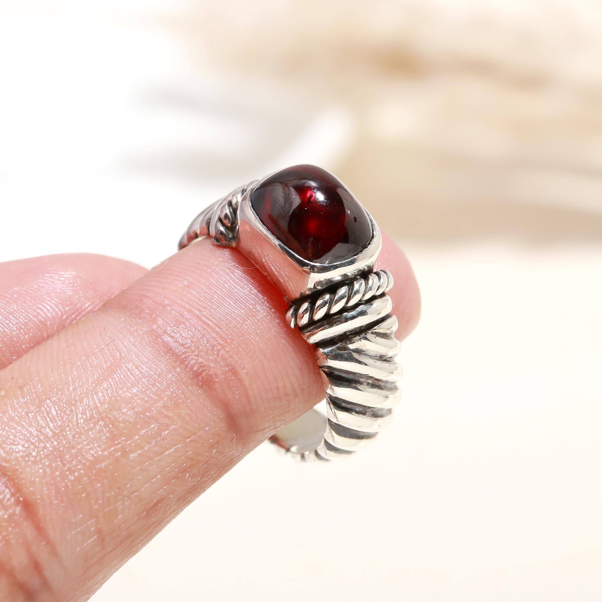 Elegant red garnet rope ring on finger