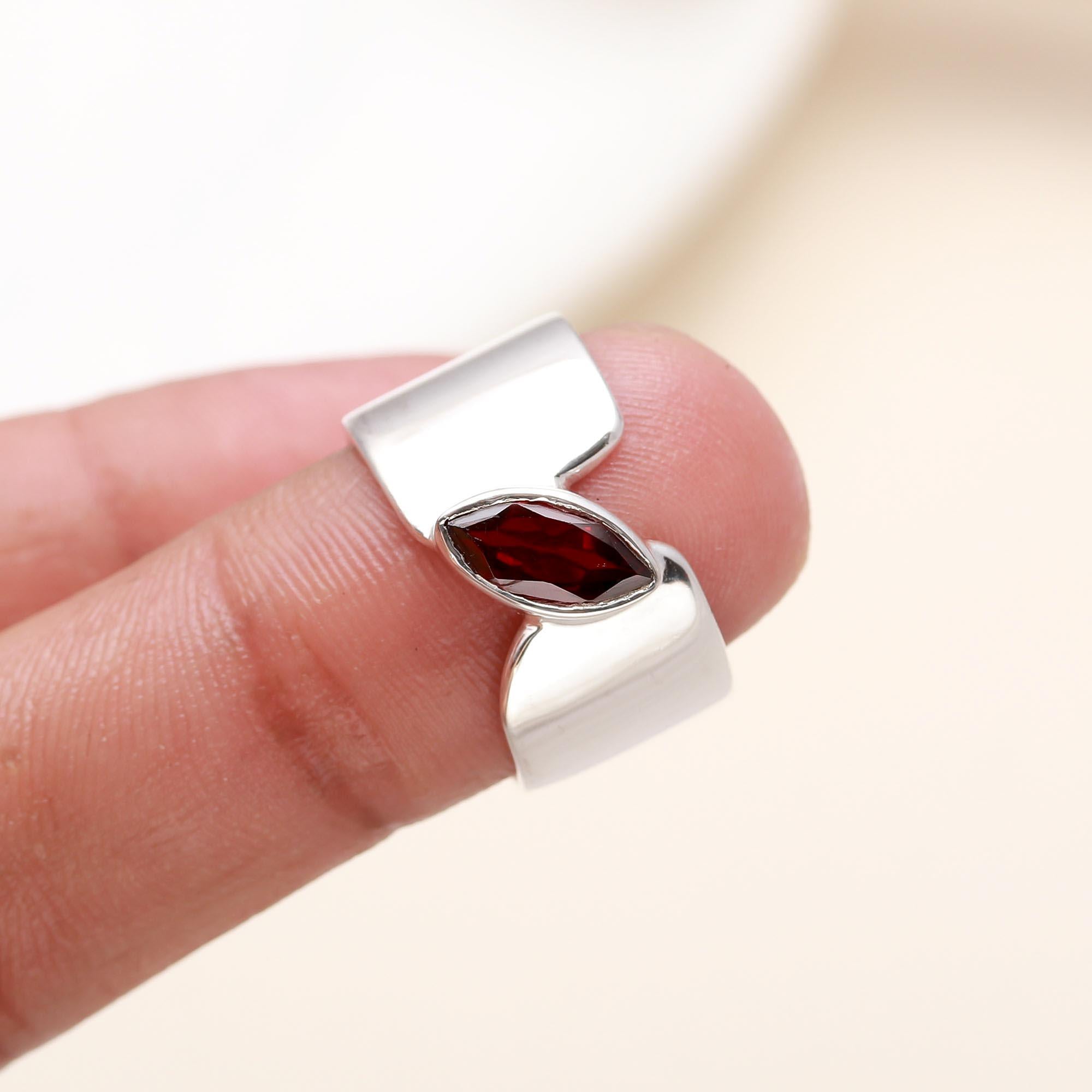 Elegant marquise garnet ring on finger
