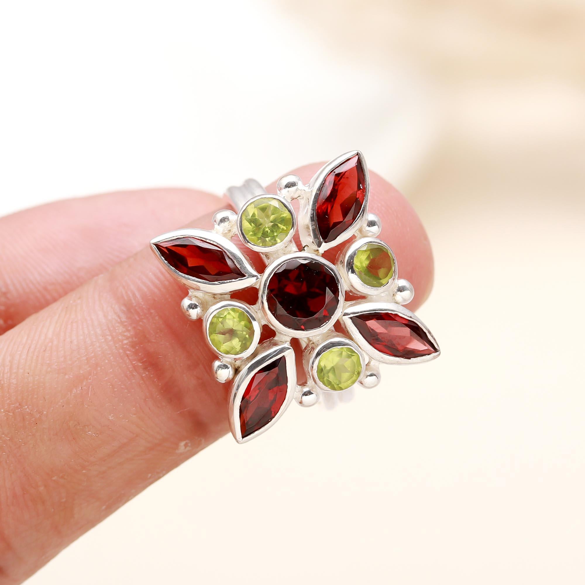 Elegant floral ring with red garnet and green peridot stones