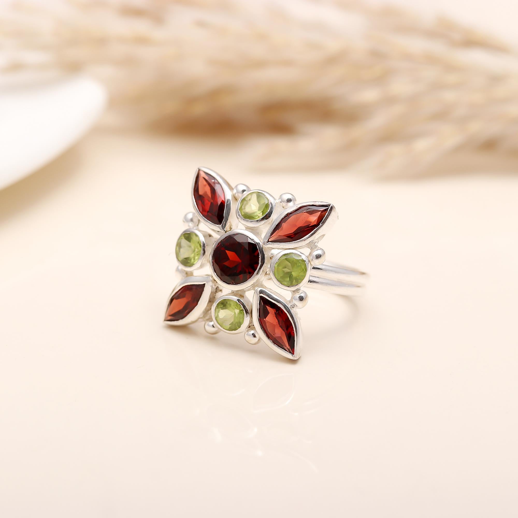 Detailed flower design in sterling silver with gemstones