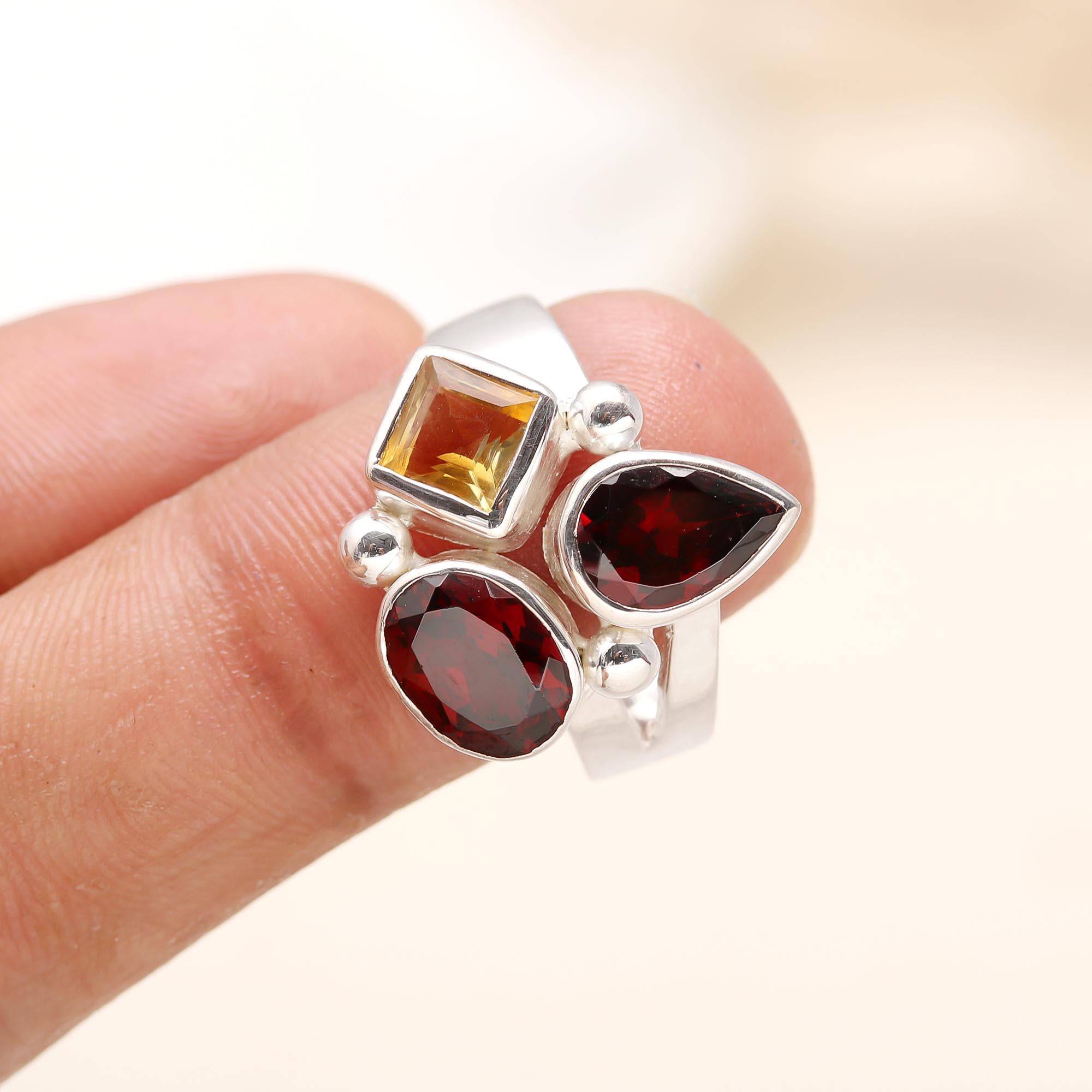 Close-up of multi-shape garnet and citrine gemstones set in sterling silver