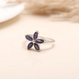Hand model wearing 925 silver iolite petal flower ring