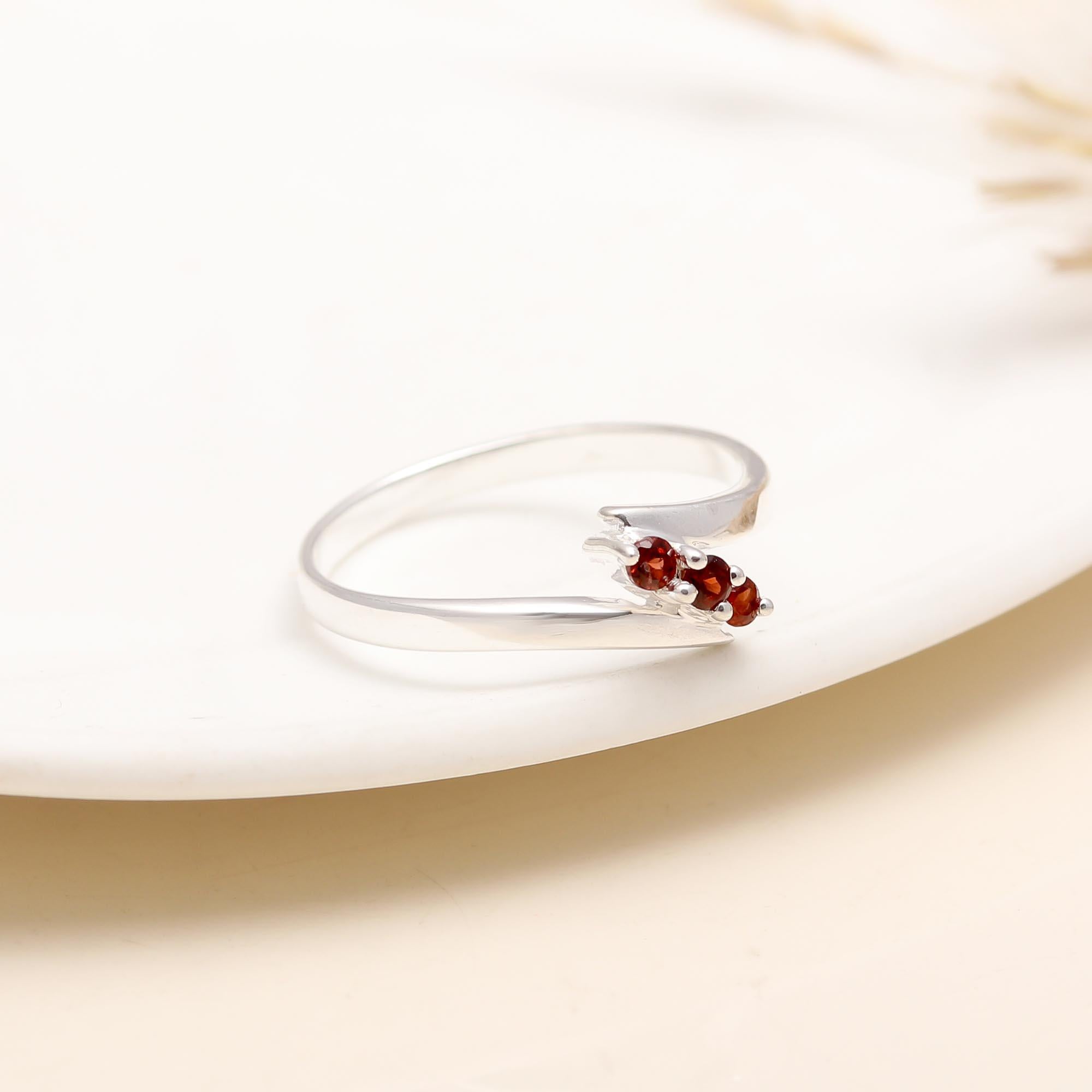 Sterling silver overlapping ring with red garnet