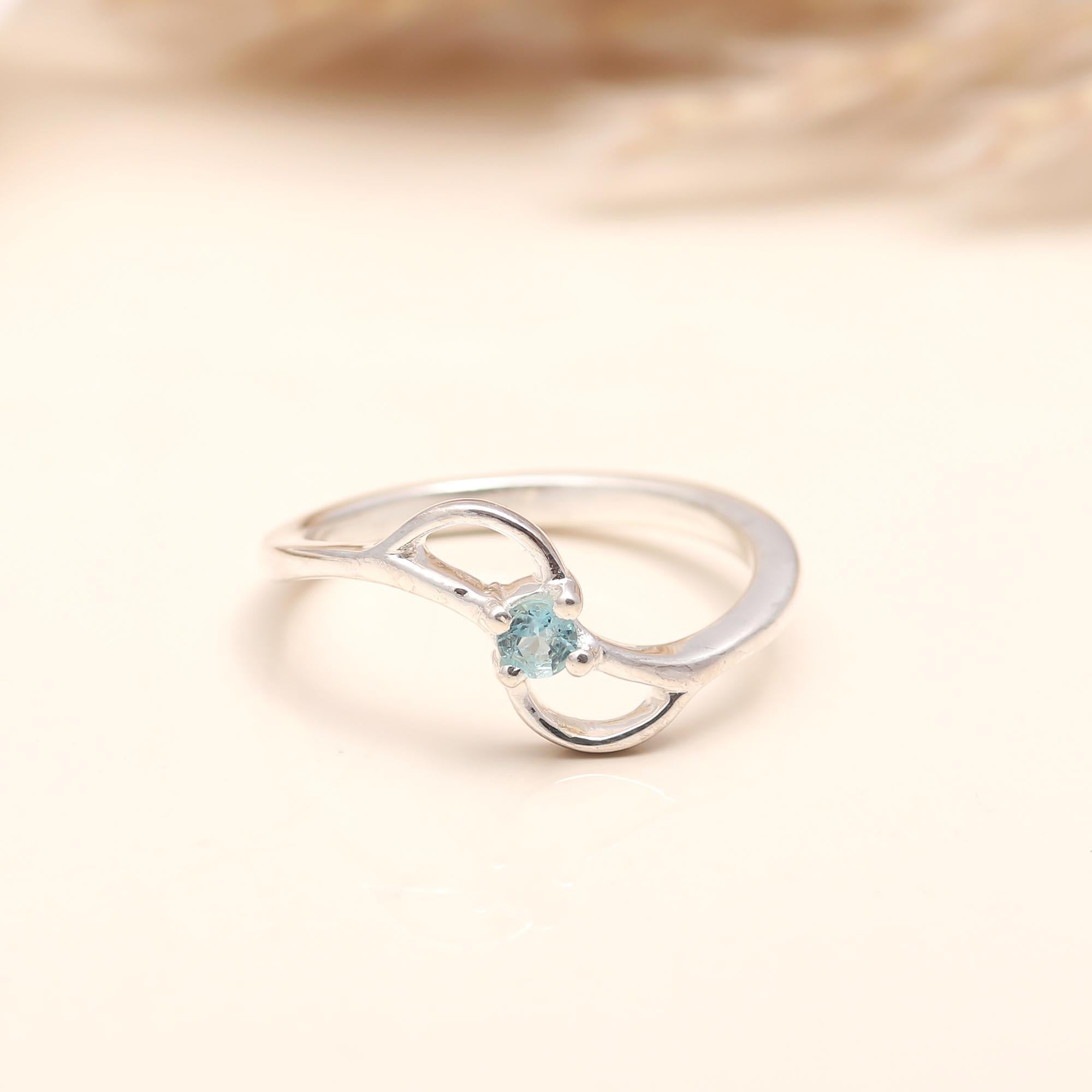 Handcrafted silver ring featuring natural blue topaz