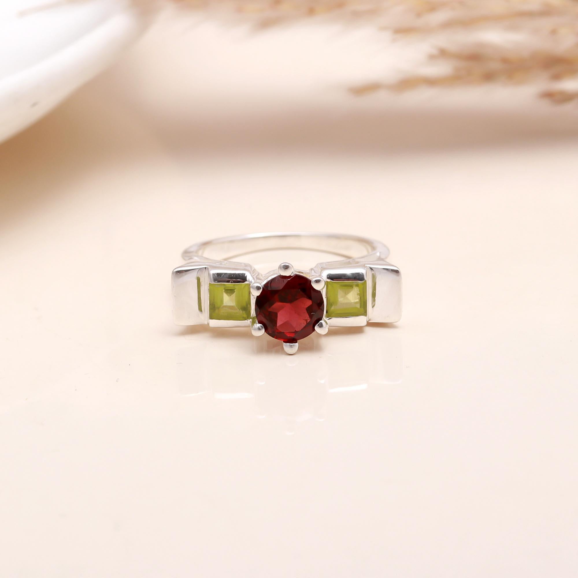 Close-up of garnet and peridot square stone silver ring