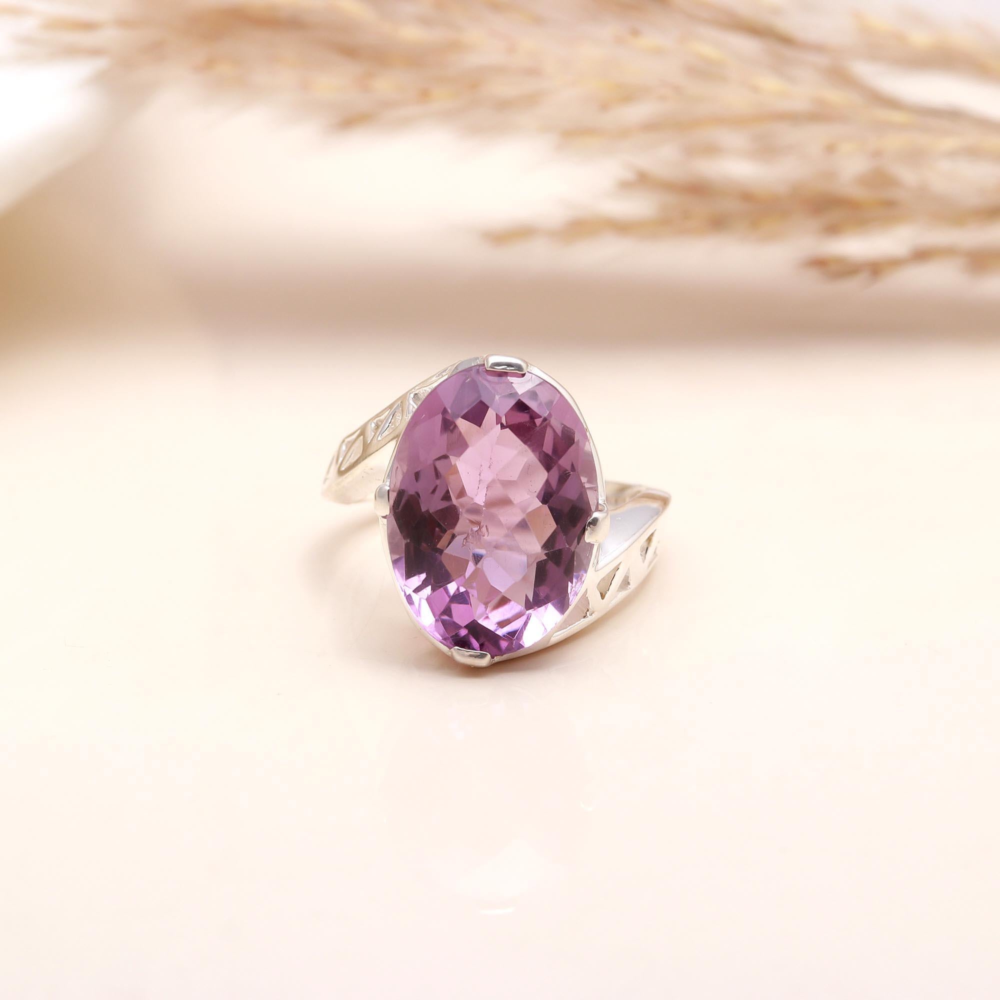 Oval-cut faceted amethyst set in sterling silver band