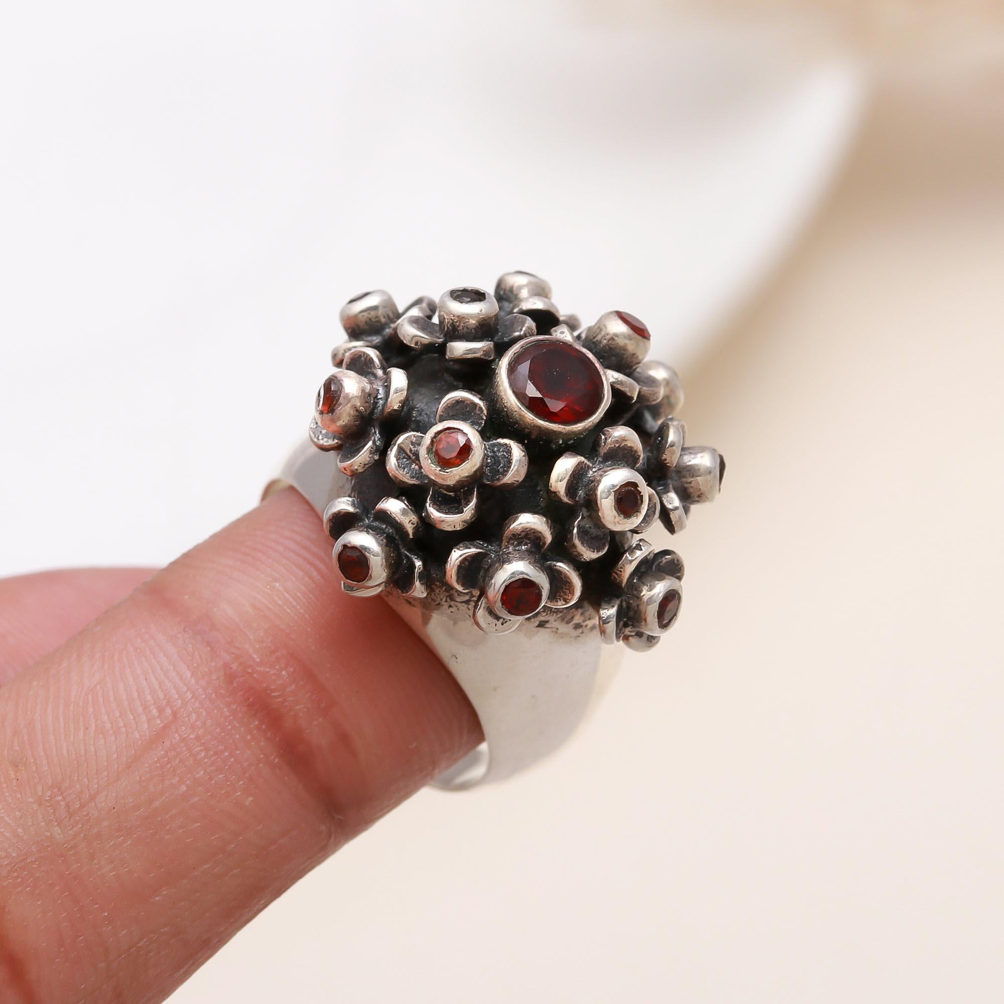Elegant garnet dome ring on finger